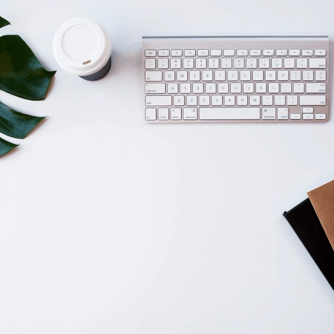 Marketer planning social media posts with a laptop and phone